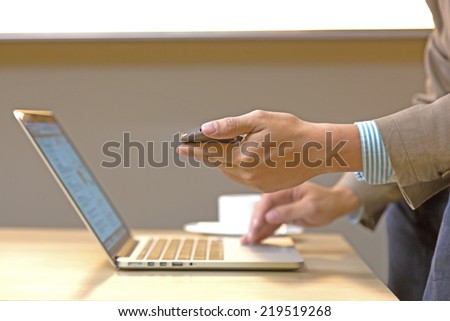 Young businesswoman working with modern devices, digital tablet computer and mobile phone.