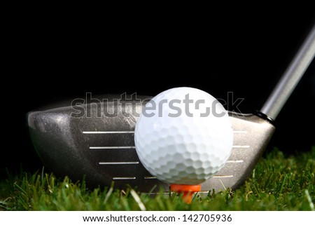 Golf club ready to hit golf ball on white background