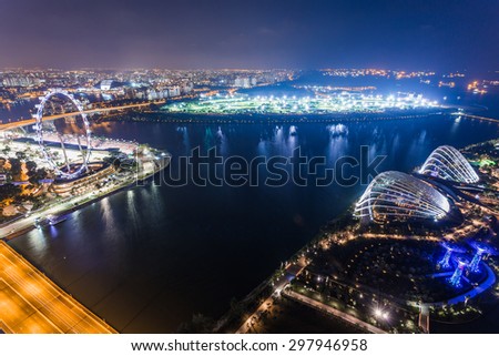 SINGAPORE - FEBRUARY 27, 2015: aerial view of Garden by the Bay and Singapore Flyer at night. Garden by the Bay and Singapore Flyer are the famous tourist attraction in Singapore.