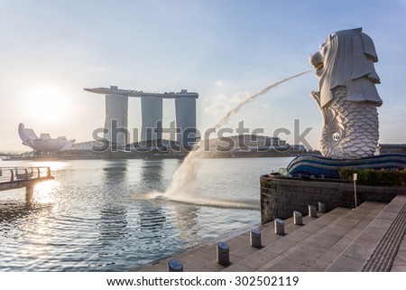 SINGAPORE - MARCH 1, 2015: Sunrise scene of Singapore skyline with merlion on march 1, 2015. Merlion fountain is one of the most famous tourist attraction in Singapore.
