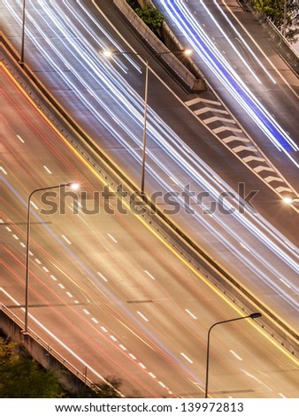 Curve of tollway traffic movement at night. Shot in bird\'s eye view.