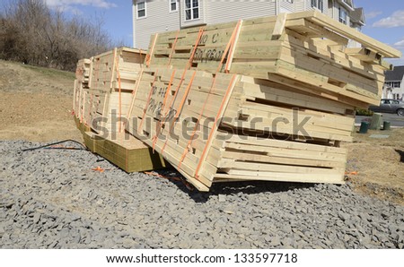 stack of new lumber ready for the construction of a new home