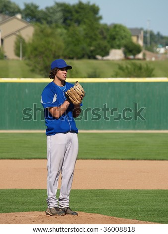 high school baseball pitcher on the pitcher\'s mound