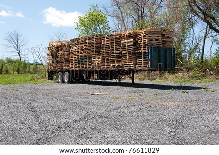 many wood pallets sitting on a flatbed truck