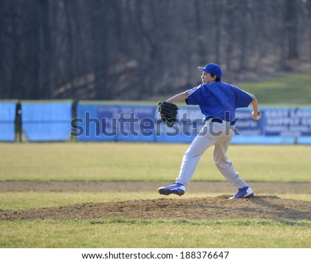 teenage baseball pitcher on the pitcher\'s mound