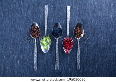 five spoons with food and spices, design, blue background, caviar, garnet