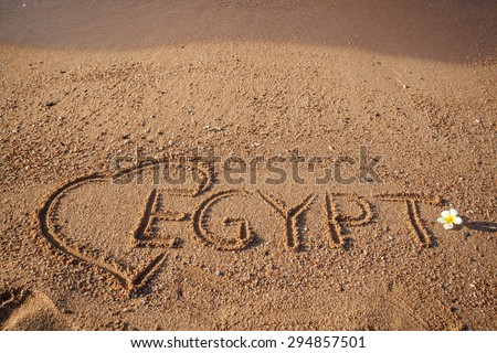 Wallpaper, the Red  Sea holidays background. Inscription Egypt and exotic flower  on the sand. Love Egypt