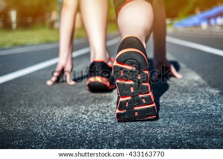 Young Girl Runner feet on track closeup focus on sport shoe. Getting ready to start