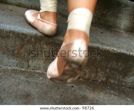 young ballerina walking up old stairs wearing point shoes