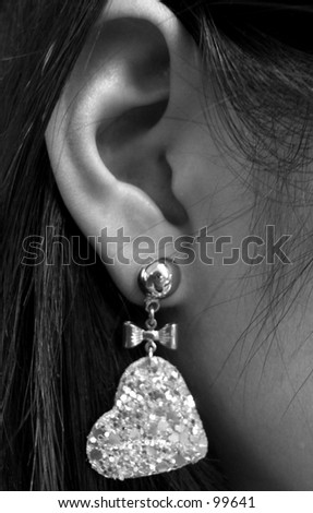 black and white woman with diamond heart earing