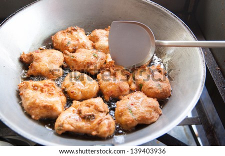 Frying corn meal mush in hot oil in an iron pan