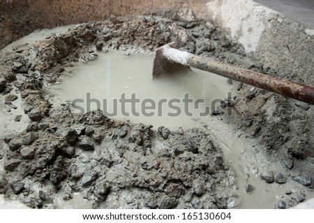 spade and wet cement image for construction process