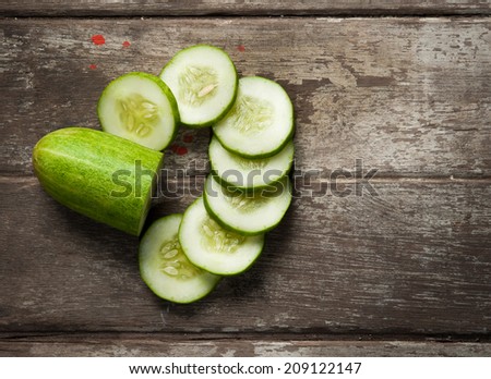 cucumber slices on wooden background