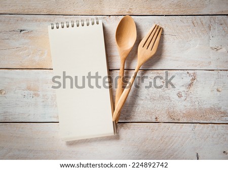 blank recipe book with wooden spoon