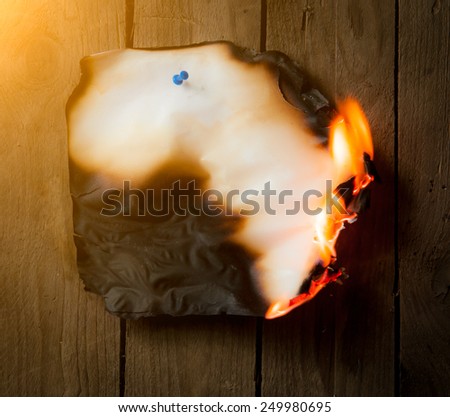 Fire paper on wooden background