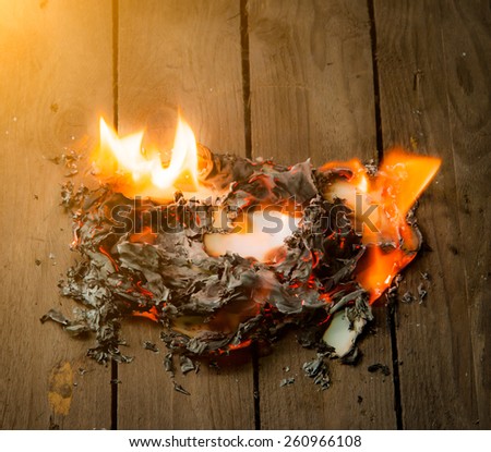 Fire paper on wooden background