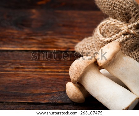 King trumpet mushrooms on a wooden background