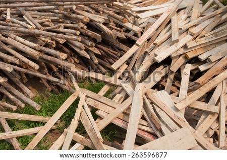 Pile of old and dirty lumber in construction site