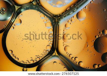 Oil drops on a water surface, Orange background