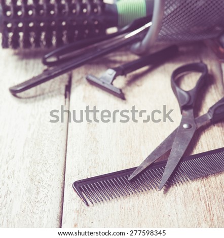 hairdresser tools on white wood,vintage color toned image