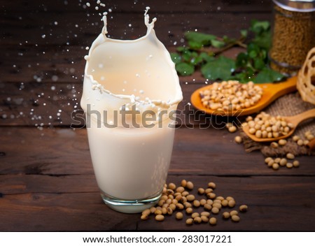Soy milk splash with beans on wood