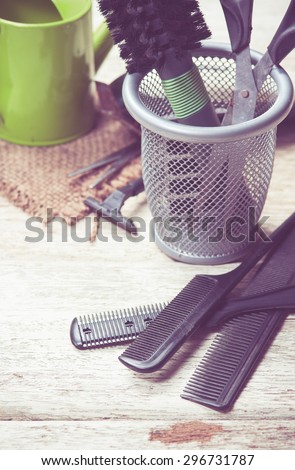 hairdresser tools on white wood,vintage color toned image