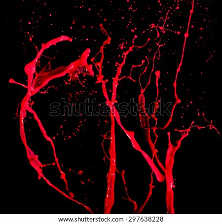 splashes of red paint isolated on black background