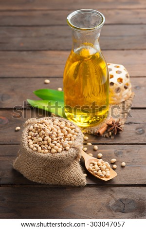 Soy bean and soy oil on wooden,Selective focus with shallow depth of field.