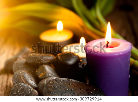 zen basalt stones, lavender candles on wooden,dark background,,Selective focus on candle