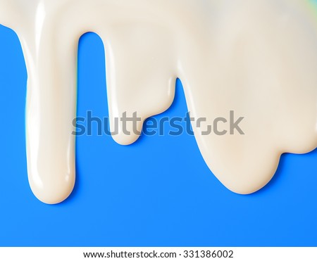 Dripping white milk, cream, paint yogurt on blue background