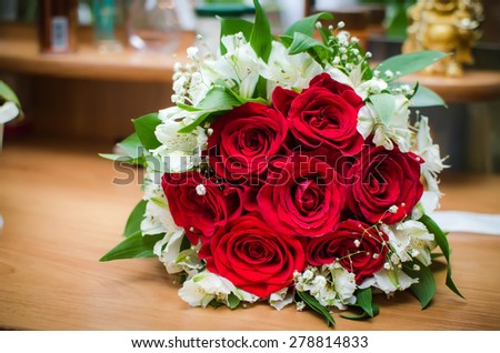 Red roses on a background of cosmetics