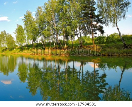 Spring Reflections - Picturesque spring landscape of river and bright trees and bushes