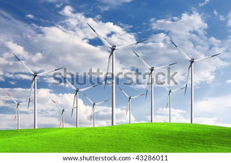 Green meadow with Wind turbines generating electricity
