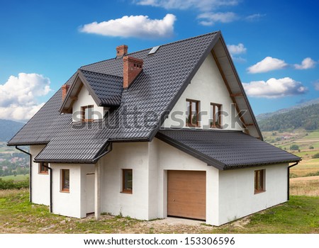A new house with a garage in a rural area