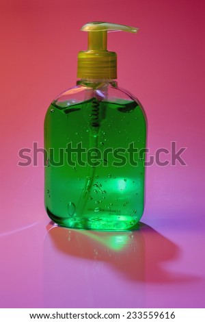 A plastic lotion bottle isolated on pink background