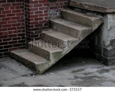Concrete steps against a red brick wall at rear of business.