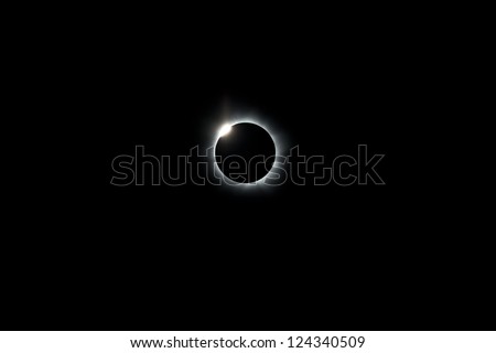 During the 2012 total solar eclipse the moon has completely covered the sun, leaving only a ring of light where the sun has been eclipsed.  A diamond ring appears as the moon slips off the sun.