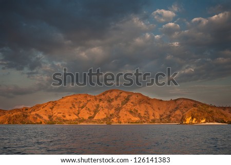 The late afternoon sun lights the island of Komodo where Komodo dragons roam.  This area is known both for its dragons and its spectacular scuba diving.