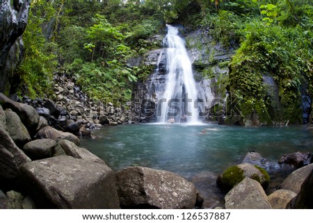 A waterfall cascades into a large pool on Cocos Island, Costa Rica.  Cocos is known for it large shark populations and great scuba diving.