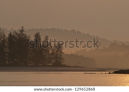 Early morning mist flows along the tropical shores of an island in the Mergui Archipelago, Myanmar.  This remote group of islands is inhabited by Moken, the last remaining sea gypsies.