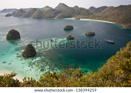 Limestone islands form a remote lagoon in northern Raja Ampat, Indonesia.  This aesthetic area is known as Wayag.
