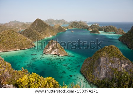 Limestone islands form a remote lagoon in northern Raja Ampat, Indonesia.  This aesthetic area is known as Wayag.
