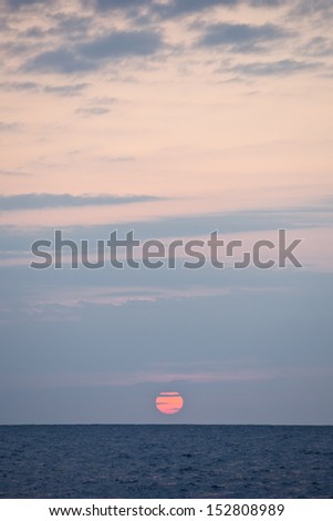 The sun sets on the Caribbean Sea.