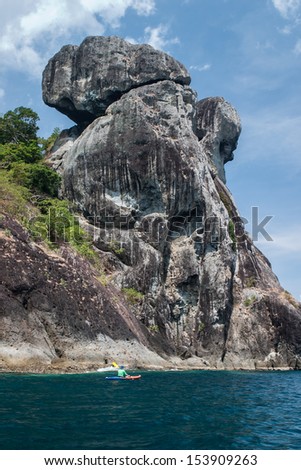 A kayaker paddles along the edge of a remote island in the Mergui Archipelago, Myanmar. This group of tropical islands in the Andaman Sea is rarely visited yet are extremely beautiful.