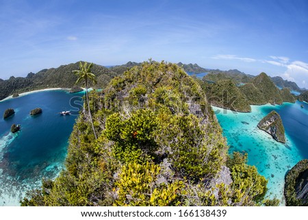A gorgeous set of limestone islands, covered by tropical vegetation, make up an area known as Wayag in Raja Ampat, Indonesia. This region is known for its high marine biological diversity.