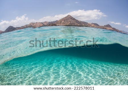 Brilliant sunshine sparkles on a shallow sand flat in the tropical Pacific Ocean. Sunlight plays a vital role in a variety of tropical underwater habitats.