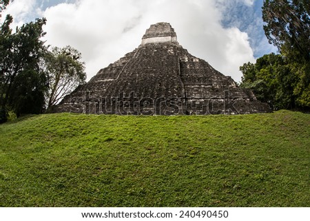 A Mayan temple rises out of the jungle in Tikal National Park, northern Guatemala. This archaeological site is one of the largest urban centers of pre-Columbian Maya civilization.