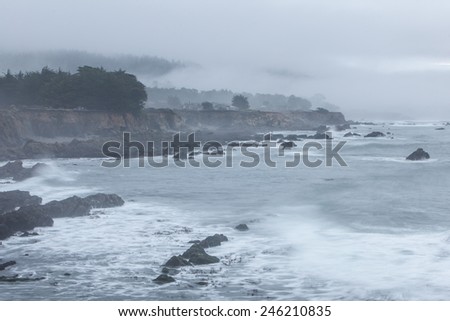 Fog and Pacific ocean waves wash against the rocky shore of California. Wave energy has helped shape the shoreline of the entire west coast.
