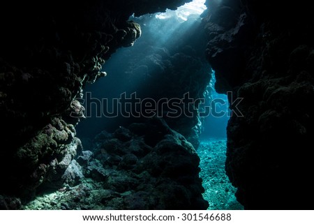 Sunbeams fall into the dim shadows of a cavern in the Solomon Islands. Coral reefs in this Melanesian region are exceedingly diverse. The area also offers great scuba diving and snorkeling.