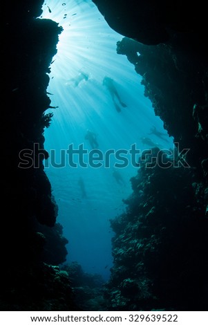 A cavern opens into blue water on Palau\'s barrier reef. Palau, in Micronesia, is known for its highly biodiverse coral reefs and spectacular diving and snorkeling.